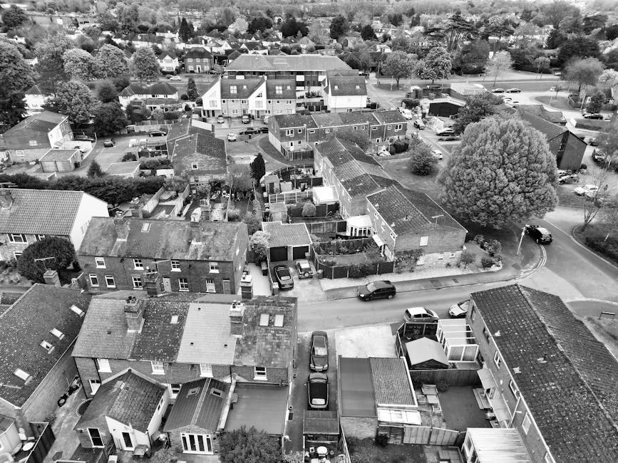 A black and white aerial view of a residential neighborhood in Cranford, showcasing a variety of garden layouts and outdoor spaces. The image features several detached and semi-detached houses with pi